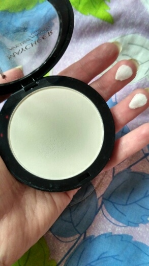 A buyer is showing frontside of an open white pressed powder
