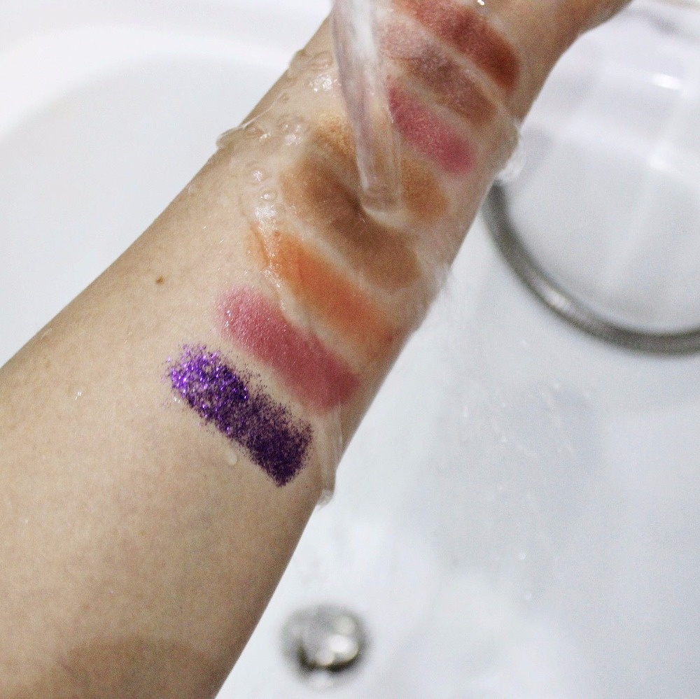 Rinse a lady's arm wearing pigment eyeshadows with water